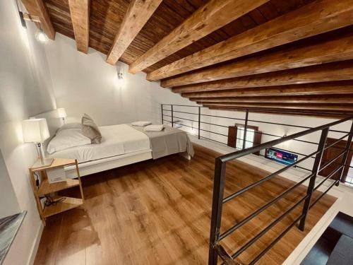 a bedroom with a bed and a wooden ceiling at Palermo Inn Boutique Hotel in Palermo