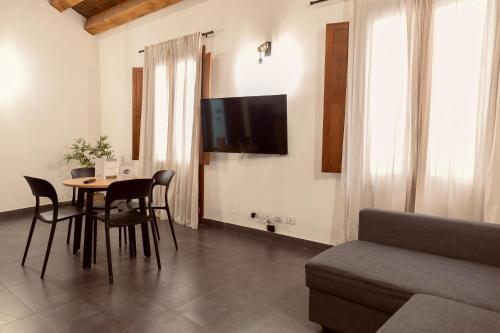 a living room with a table and a couch at Palermo Inn Boutique Hotel in Palermo