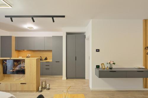 a kitchen and a living room with a counter at Mountain Bliss in Sinaia