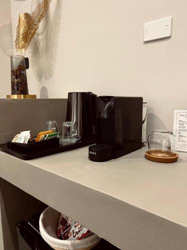 a counter top with a coffee maker on it at Palermo Inn Boutique Hotel in Palermo