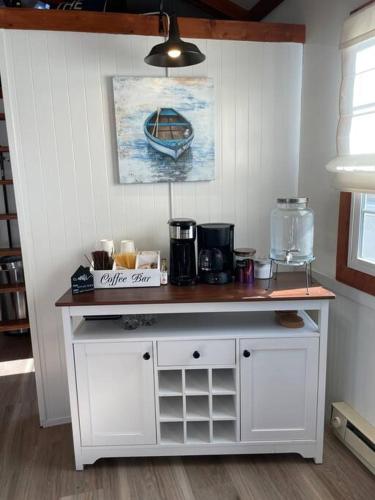 a white counter in a kitchen with a table at Houseboat in Providence! in Providence