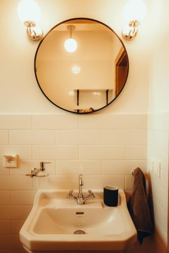 a bathroom with a sink and a mirror at Domki Smokowo in Gołubie
