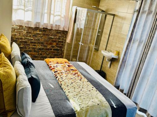 a bathroom with a bed and a shower and a sink at Ts Group Africa furnished apartments - Marothwane Saturday Sebola in Pretoria