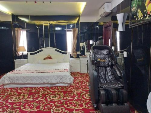 a bedroom with a bed and a chair in it at Nhat Quy Hotel in Tây Ninh