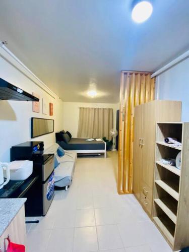 a room with a kitchen and a living room at Plumera Condo Near Airport Malls & Schools with Elevator in Lapu Lapu City