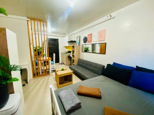 a living room with a couch and a table at Plumera Condo Near Airport Malls & Schools with Elevator in Lapu Lapu City