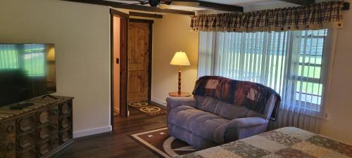 a living room with a couch and a television at Trickling Waters Retreat in Marquette