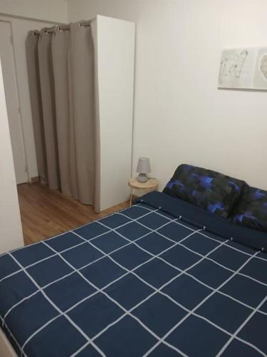 - une chambre dotée d'un lit et de carrelage bleu dans l'établissement Appartement, à Sexey-aux-Forges