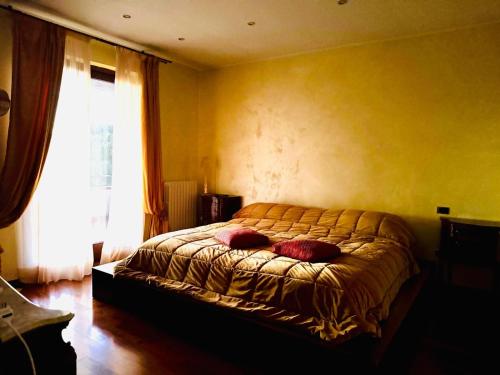 a bedroom with a bed with two pillows on it at Villa Elena in Montefiascone