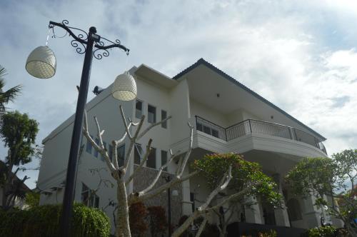 a building with a street light in front of it at Flamingo Aquila in Badung