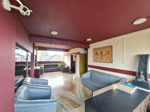 a living room with blue couches and a table at B FINE Guest House in Shillong