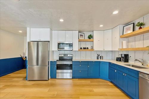 a kitchen with blue cabinets and stainless steel appliances at Private Room & Bathroom Quiet Neighborhood in Ogden