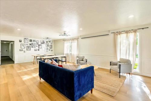 a living room with a blue couch and a table at Private Room & Bathroom Hiking Trails Close By in Ogden