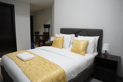 a bedroom with a large bed with yellow pillows at Ista Vacation Homes Rental LLC in Dubai