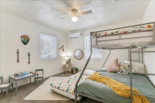 a bedroom with a bunk bed and a desk at 5 Mins off i15 Pickle Ball Courts Close By in Bountiful