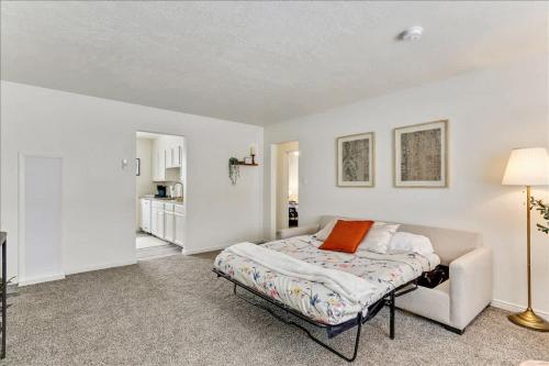 a white bedroom with a bed and a couch at 5 Mins off i15 Pickle Ball Courts Close By in Bountiful