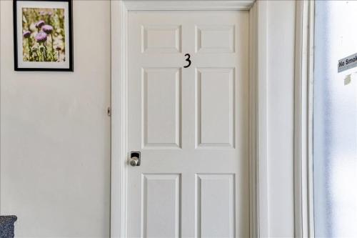 a white door with the number three on it at 5 Mins off i15 Pickle Ball Courts Close By in Bountiful