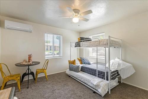 a bedroom with a bunk bed and a table at Pickle Ball Courts Close By 5 Mins off i15 in Bountiful
