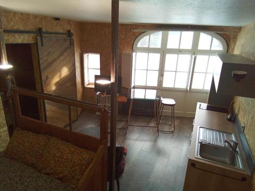 a room with a kitchen with a sink and a stove at Comme à la maison in Tiffauges
