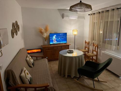 a living room with a table and a tv at ML Cazorla Dreams Parking Gratis in Cazorla