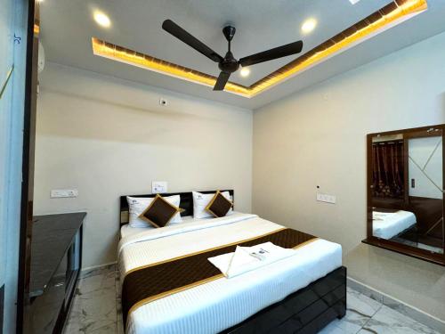 a bedroom with a large bed with a ceiling fan at Urban Nest Homestay in Tirupati