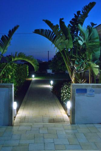 a walkway with lights on it at night at B&B Domus Terra Mare in Torre San Giovanni Ugento