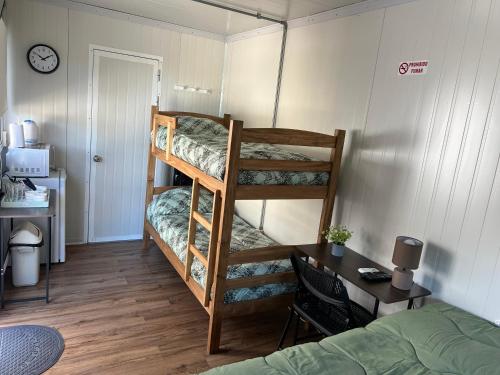 a room with two bunk beds and a desk at Apart del Este Loft 12 in Paysandú