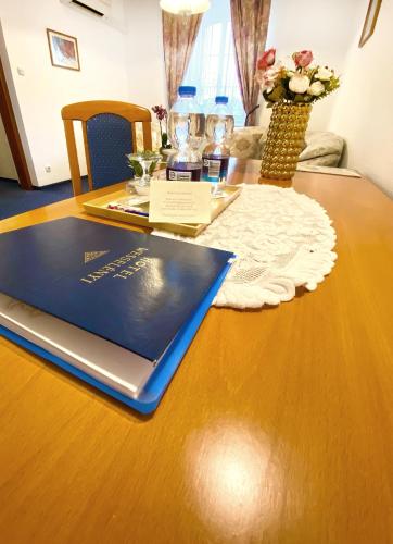 a laptop sitting on top of a wooden table at Hotel Wesselényi in Győr