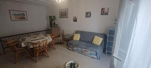 un salon avec un canapé bleu et une table dans l'établissement Type 2 quartier du port 2 à 4 personnes, à Saint-Chamas