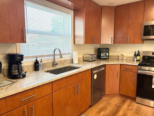 a kitchen with wooden cabinets and a sink at Saugerties Waterfront Getaway in Saugerties