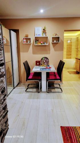 a dining room with a table and chairs at Spirit Apartman - Zalakaros in Zalakaros