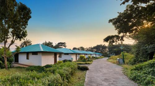 a row of white buildings with blue roofs at Aamby Valley City in Lonavala