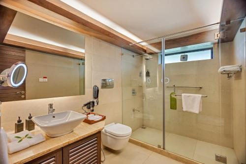a bathroom with a sink toilet and a shower at Aamby Valley City in Lonavala