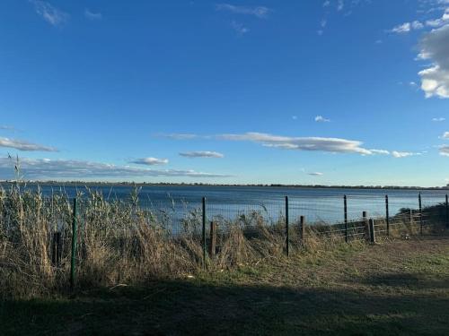 a view of a body of water with a fence at Joli Bungalow 464 pour 4-6 pers Camping Siblu Lac des Rêves Lattes in Pérols