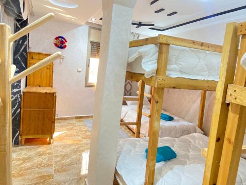a room with two bunk beds in it at Guapa Surf Morocco in Taghazout