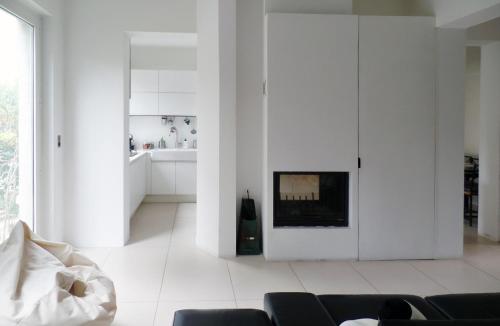 a living room with white walls and a fireplace at B&B Glicine in Civitanova Marche