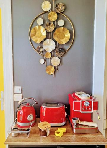 a table with a shelf with a clock on the wall at Ti Paradis Gwada Saint François, Vue Mer, Cuve à Eau, Parking Privé in Saint-François