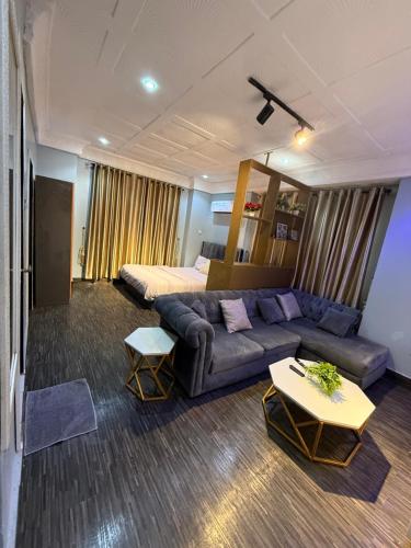 a living room with a couch and a bed at Big Studio Unit in Lekki phase 1 - Kitchen, Washer, 24-7 light, WiFi & Netflix in Lagos