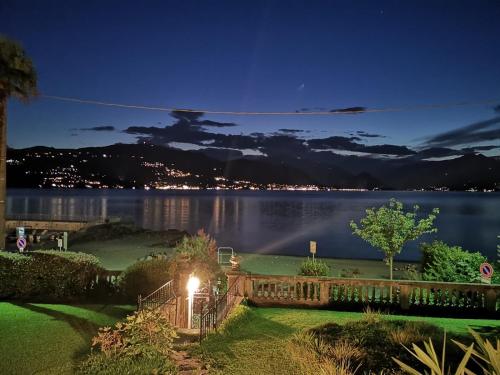a house with a view of the water at night at Villa Maria Lago Maggiore 2 in Leggiuno