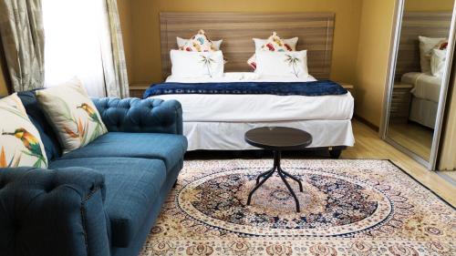 a living room with a bed and a couch at Kebo events agro &self catering apartments in Mochudi