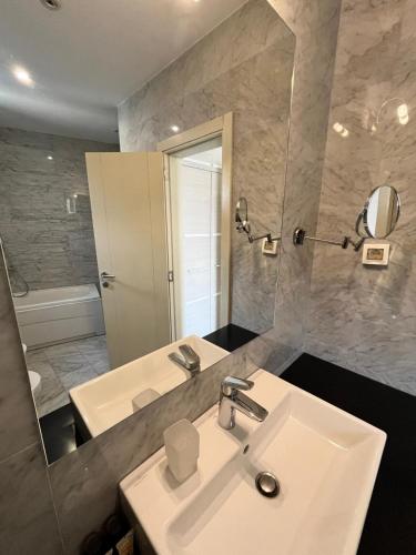a bathroom with a sink and a mirror at Hotel Atina in Budva