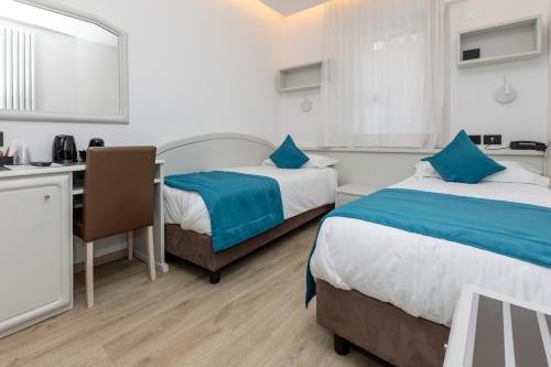 Postel nebo postele na pokoji v ubytování Albergo Cappello e Cadore