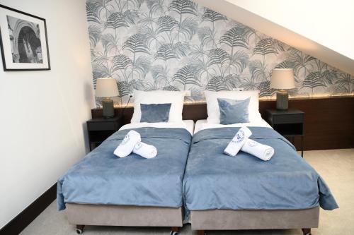 a bedroom with two beds with white shoes on them at MedHotel Smart Krupnicza w Krakowie in Kraków