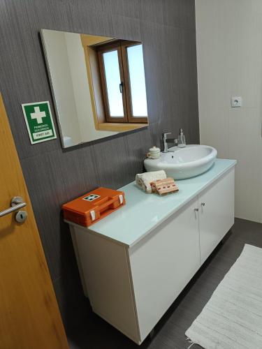 a bathroom with a sink and a mirror at Casa da Vinha in Santa Eulália