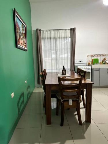a dining room table and chairs in a kitchen at Hospedaje Santiago in Sarapiquí