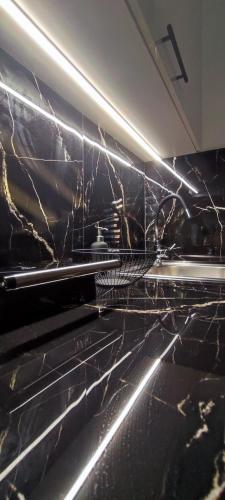 a kitchen with black marble walls and an oven at Urban Nest Veria downtown in Veria