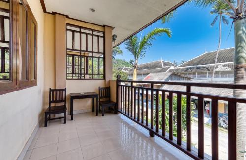 a balcony with a table and chairs and palm trees at The Bulin Residence in Lamai