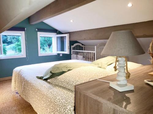 une chambre avec un lit et une table avec une lampe dans l'établissement Maison avec piscine chauffée, à Porto-Vecchio