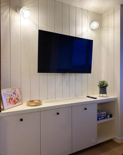 a flat screen tv on a wall in a living room at BÈTH CÈU - 4 PERS - Appart vacances- in Arette