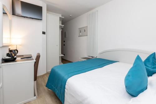 Postel nebo postele na pokoji v ubytování Albergo Cappello e Cadore